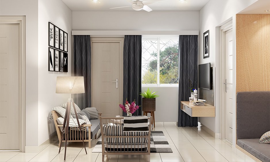 Compact small drawing room decoration with photos, lamp, flowers and potted plants add a bit of charm to space.