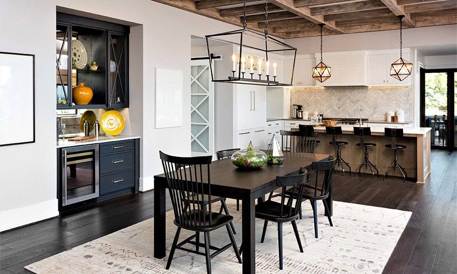 Dark farmhouse dining room table with spindle-back chairs makes a sleek appearance