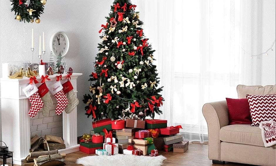 Christmas tree decoration ideas with cream and red bow ribbons and tree ornaments