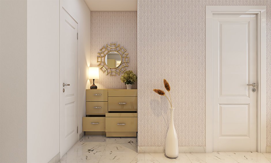 An entryway design guide with a side cabinet with multiple pull-out units helps keep your space clutter-free