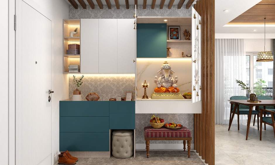 White floating pooja unit with detailed jaali work on doors and push-to-open drawer