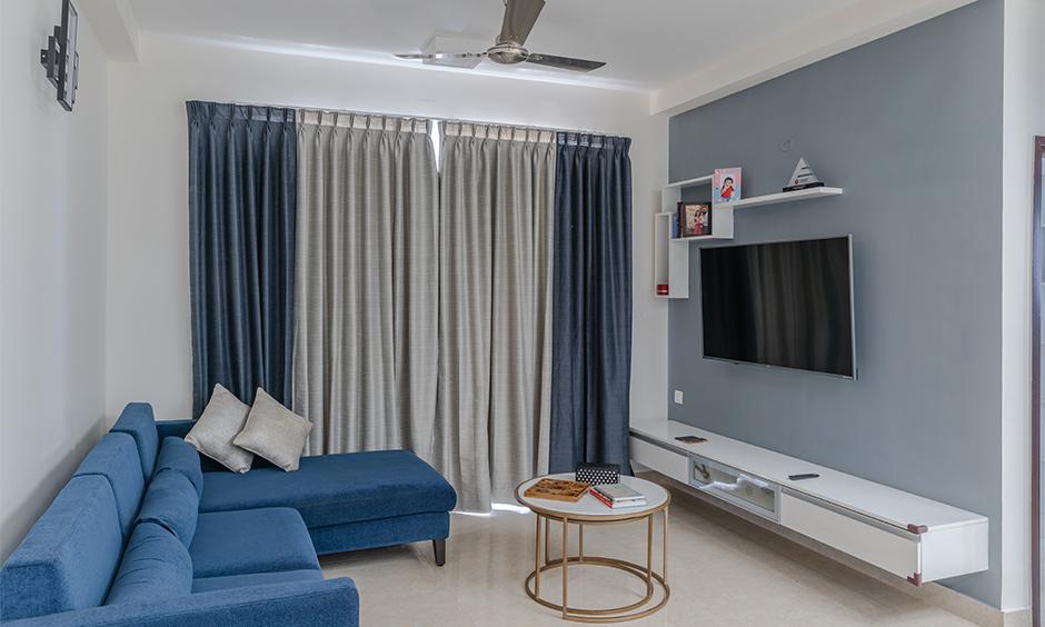 Pearl grey and dark blue combine for a calming drawing room colour scheme with serene vibes.