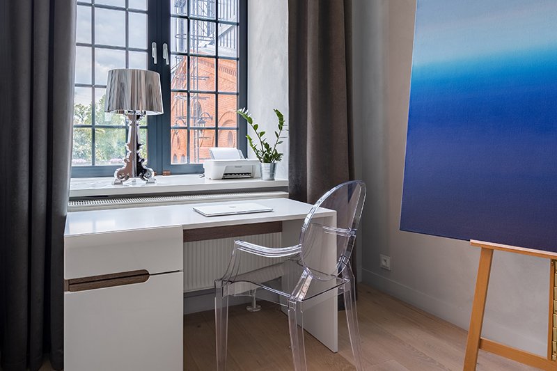 Home office study ideas with a table with drawers and a sketch board placed beside the window for fresh thoughts