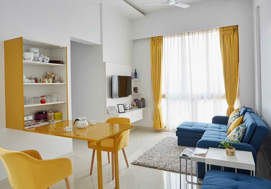 Interior decorators in mumbai for living room with a folding dining table with hidden crockery unit inside