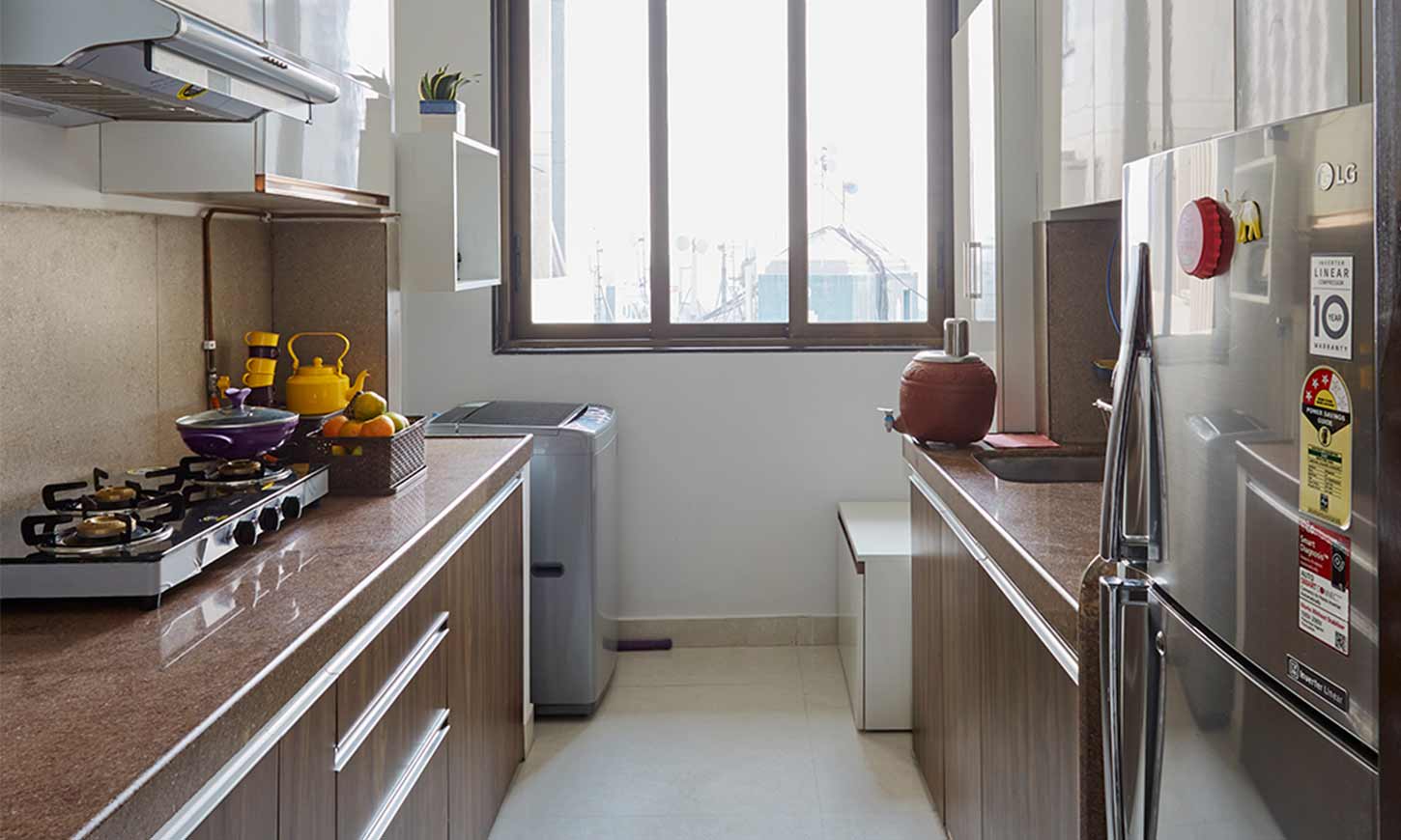 Modular kitchen designs mumbai with a parallel kitchen with brown countertops