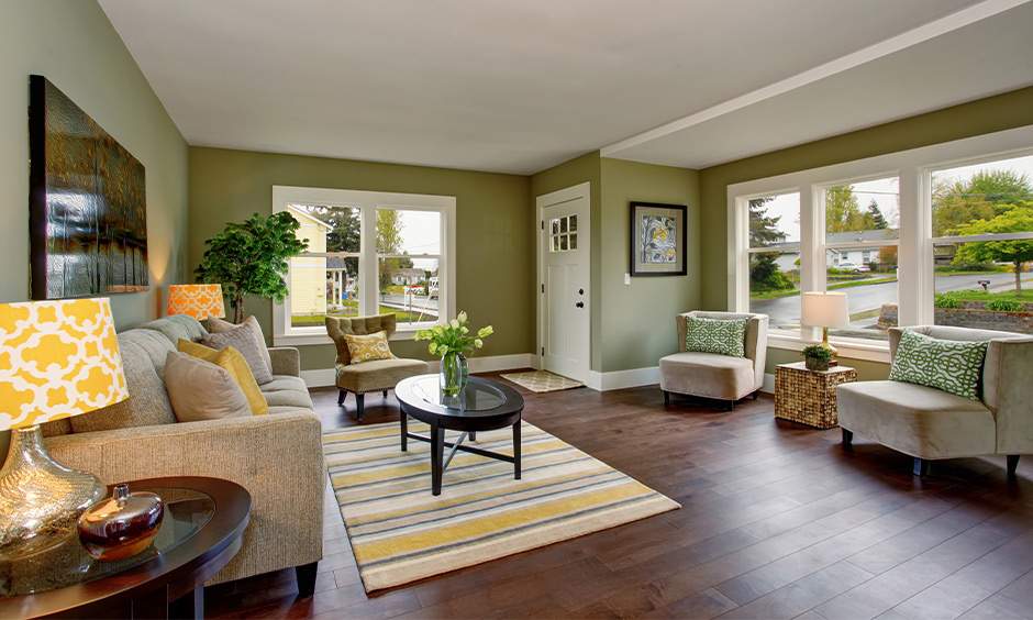 Sage green and warm white create a fresh drawing room colour design ideal for calming spaces.
