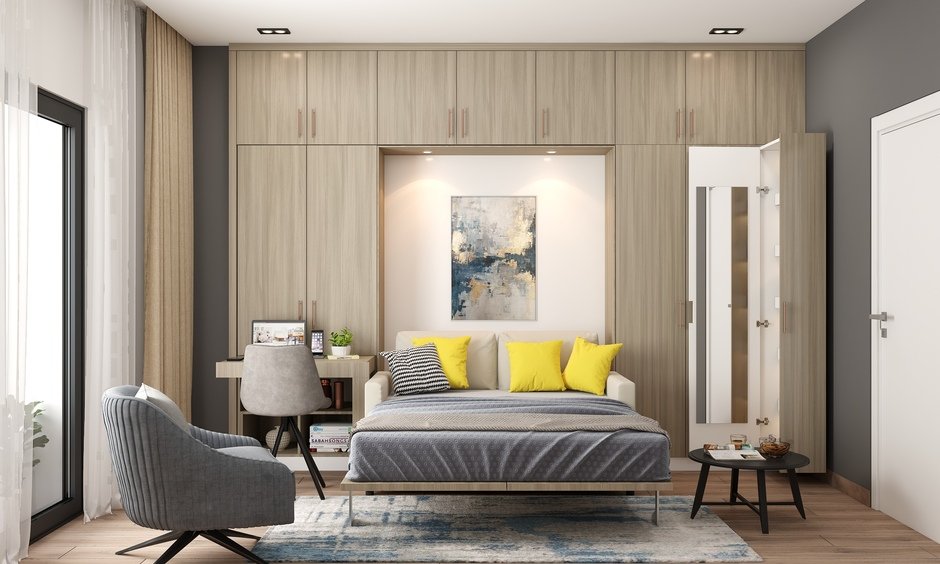 Simple interior design of a small bedroom which includes storage cabinets on the wall