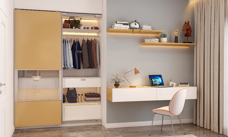 A small bedroom design with a sliding wardrobe and study table accentuate the aesthetics of the space