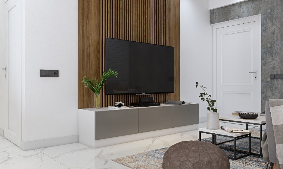 3 bhk house has tv unit with wooden panel background