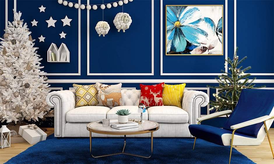 White christmas tree decoration against the dark blue accent wall